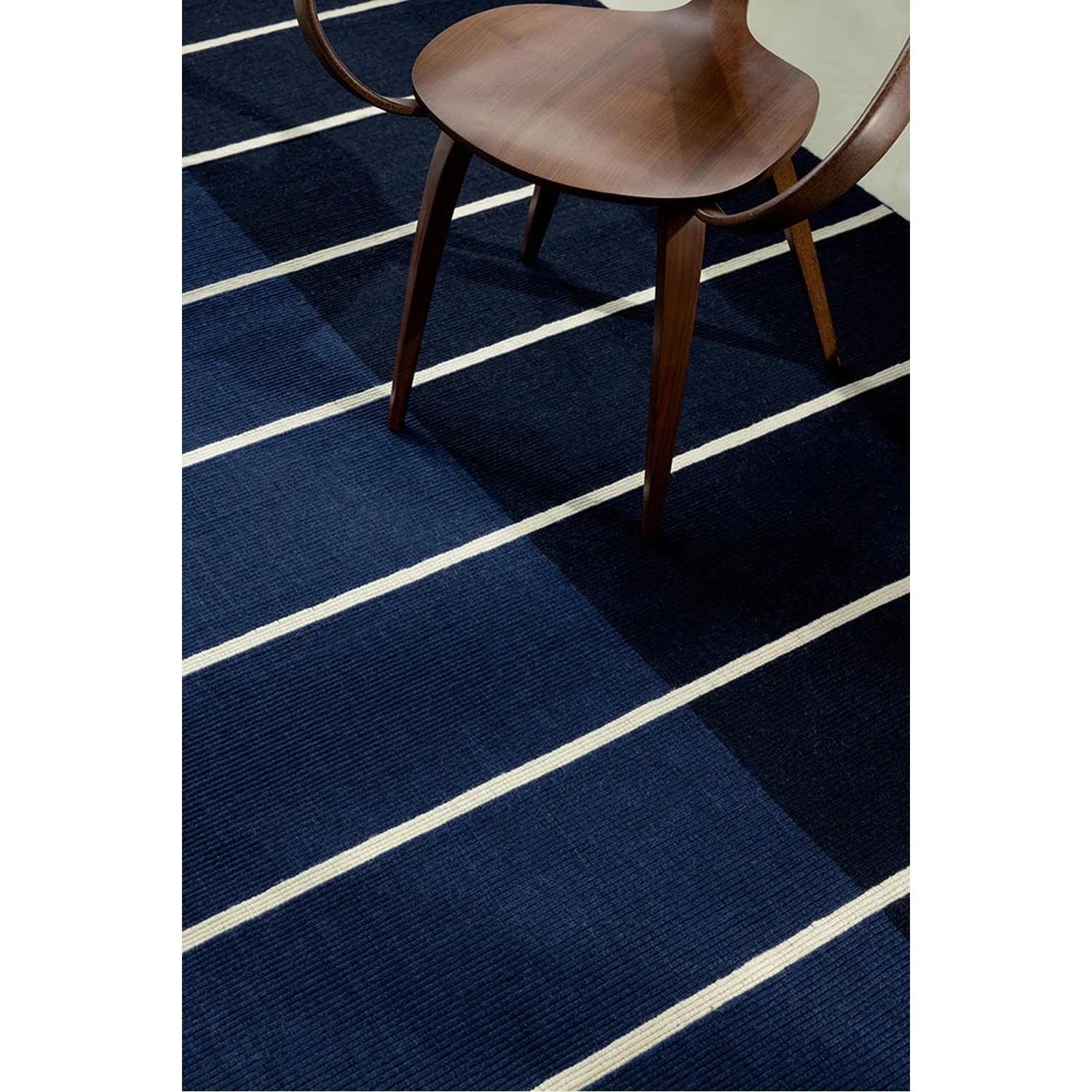 Marimekko Tiibet Deep Blue Designer Rug featuring bold stripe pattern in navy, royal blue and ivory on deep blue background, hand-tufted wool