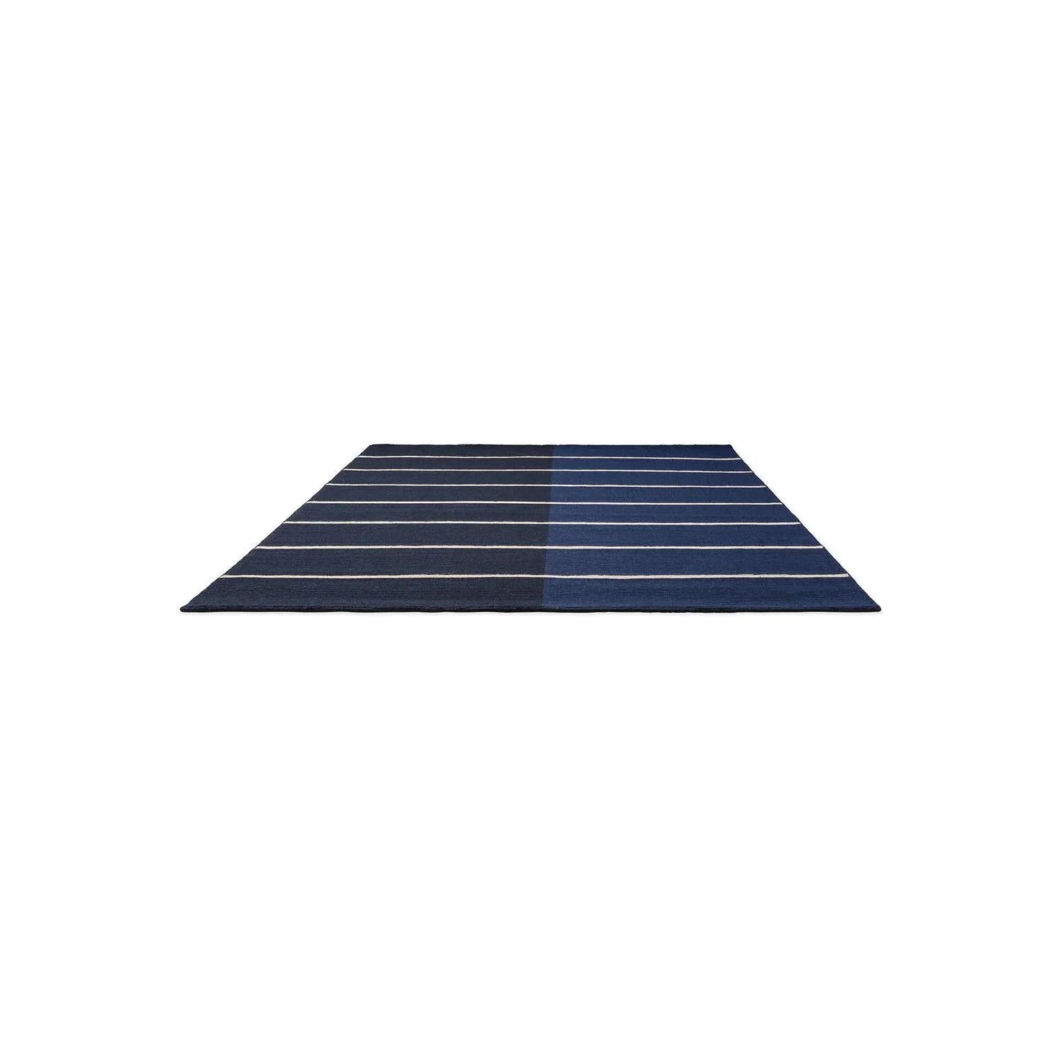 Marimekko Tiibet Deep Blue Rug by Brink & Campman featuring slim white stripes on a dark blue field, hand-tufted wool