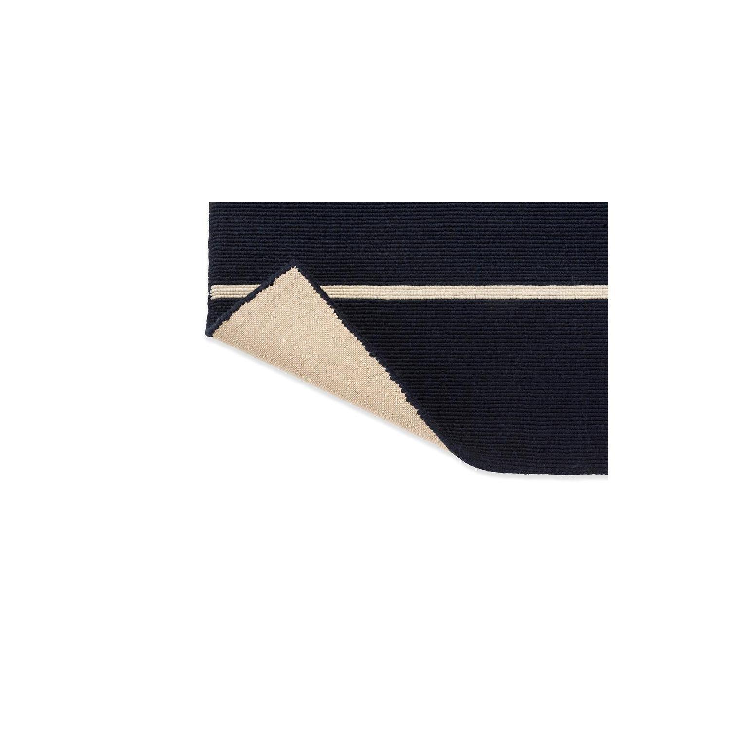 Marimekko Tiibet Deep Blue Designer Rug featuring striped geometric pattern in navy blue, cream and beige on white background, hand-tufted wool