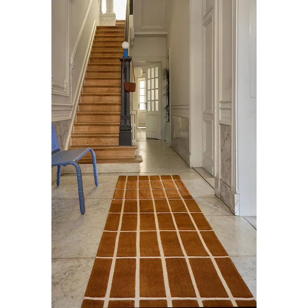 Marimekko Tiiliskivi Brown 132905 Rug with grid pattern in burnt brown and cream-white on cream floor, machine-made wool
