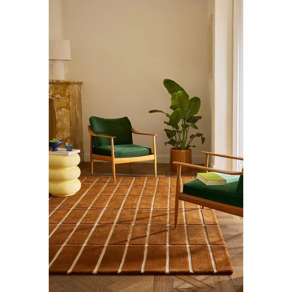 Marimekko Tiiliskivi Brown rug featuring cream, tan grid on chocolate brown on warm wood floor, hand-tufted wool