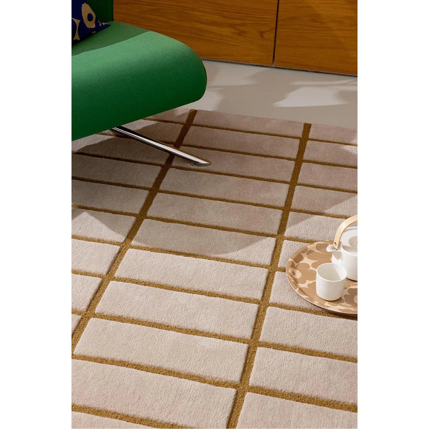 Marimekko Tiiliskivi Bronze Yellow Designer Rug featuring a brick-grid pattern in bronze and ochre on a soft beige background, machine-woven wool
