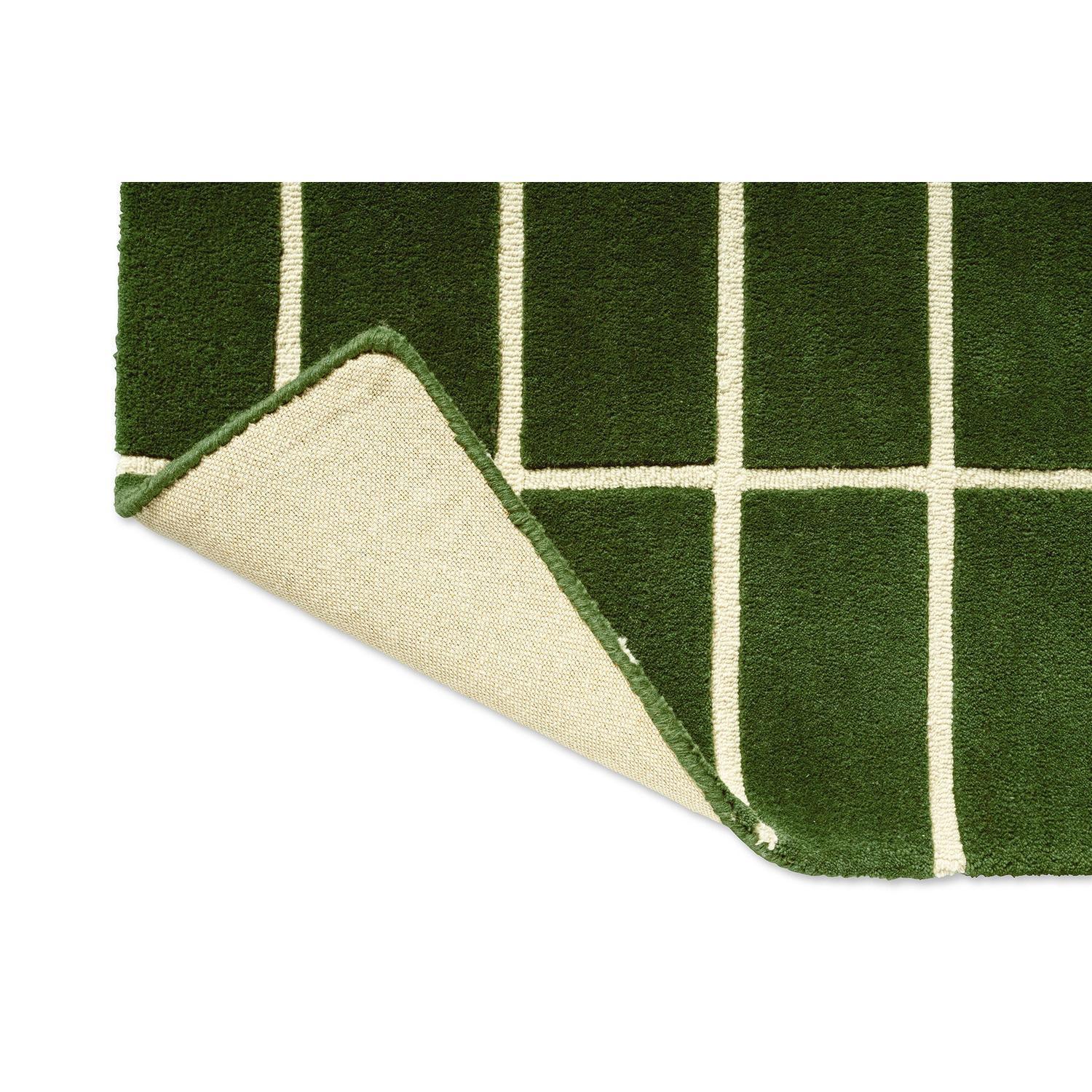 Marimekko Tiiliskivi Runner Rug featuring geometric grid pattern in forest green and cream on deep green background, hand-tufted wool
