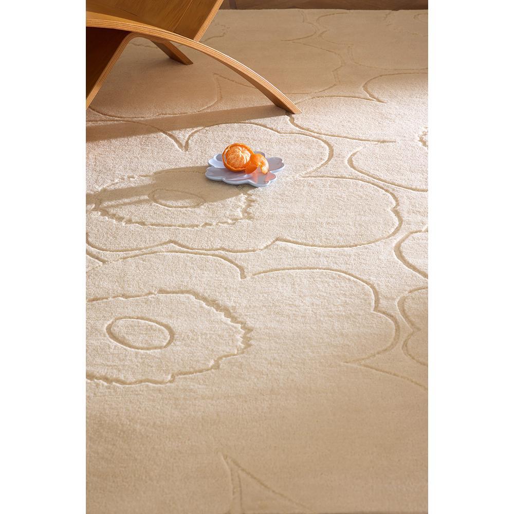 Marimekko Piirto Unikko rug featuring floral pattern in ivory, cream and beige on white background, hand-tufted wool