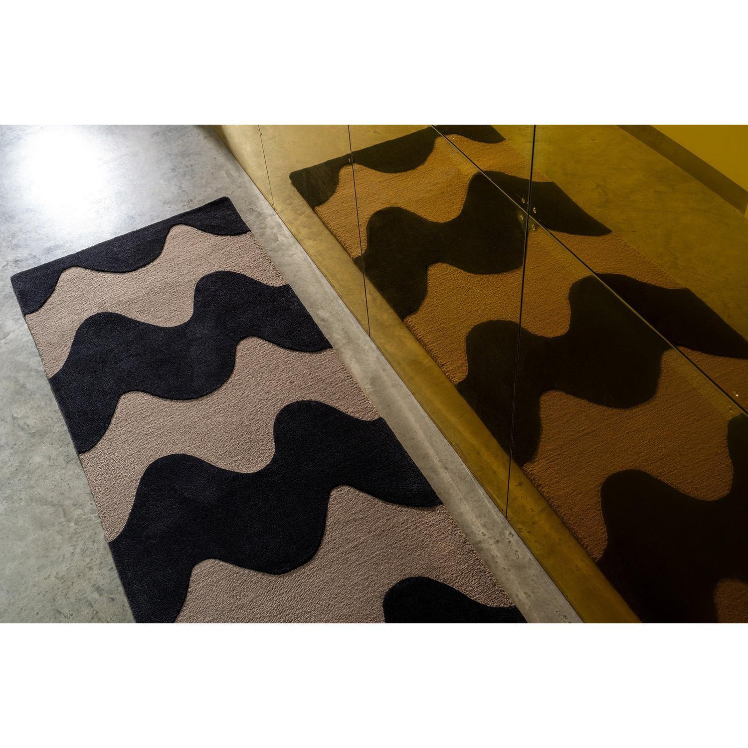 Marimekko Lokki Black 133905 Runner Rug featuring abstract wave pattern in black and beige on gray floor, woven wool