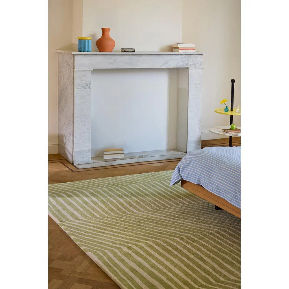 Marimekko Kalasaaski Light Green 134007 Rug with wavy stripes in sage-green and ivory on floor, machine-made cotton