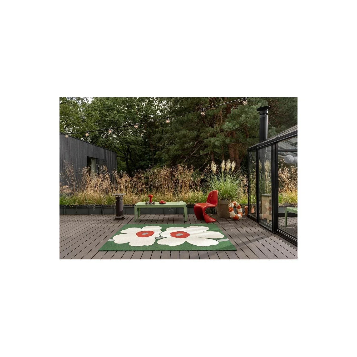Marimekko Unikko 60th Anniversary Green Rug featuring bold white poppy floral pattern with red centers on green background, machine-woven wool