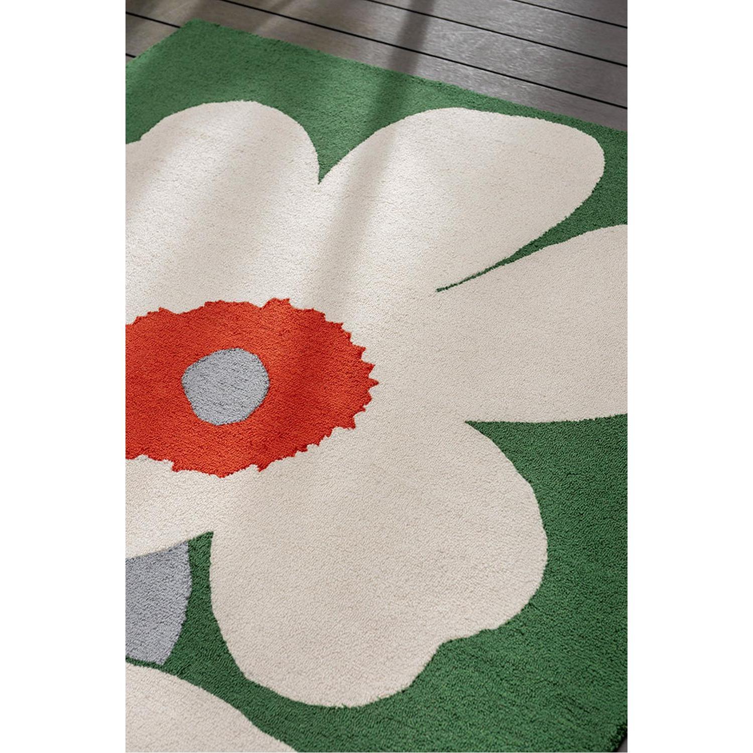 Marimekko Unikko 60th Anniversary rug featuring cream petals with red center and grey dot on green background, hand-tufted wool