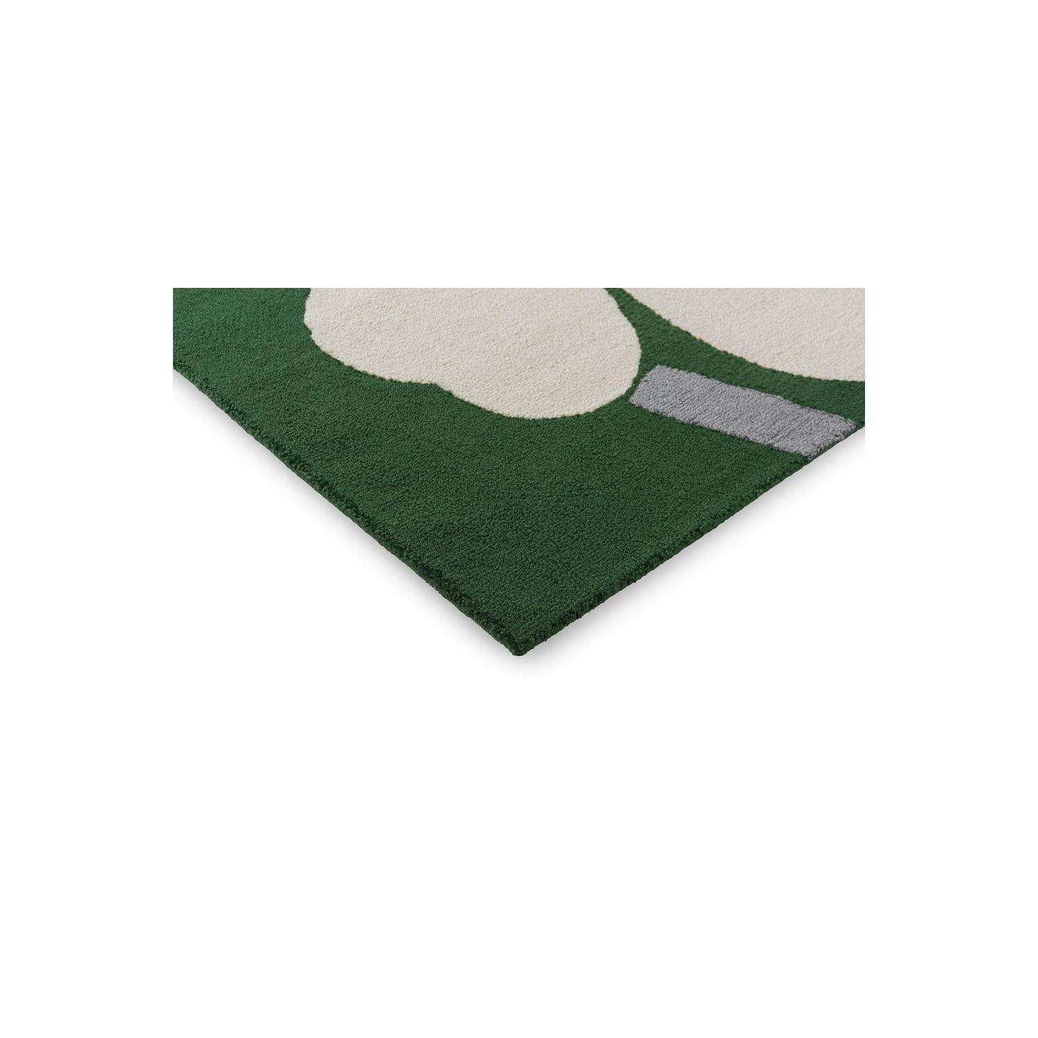 Marimekko Unikko 60th Anniversary Green Rug featuring bold cream-beige floral pattern on dark green background, machine-made wool blend