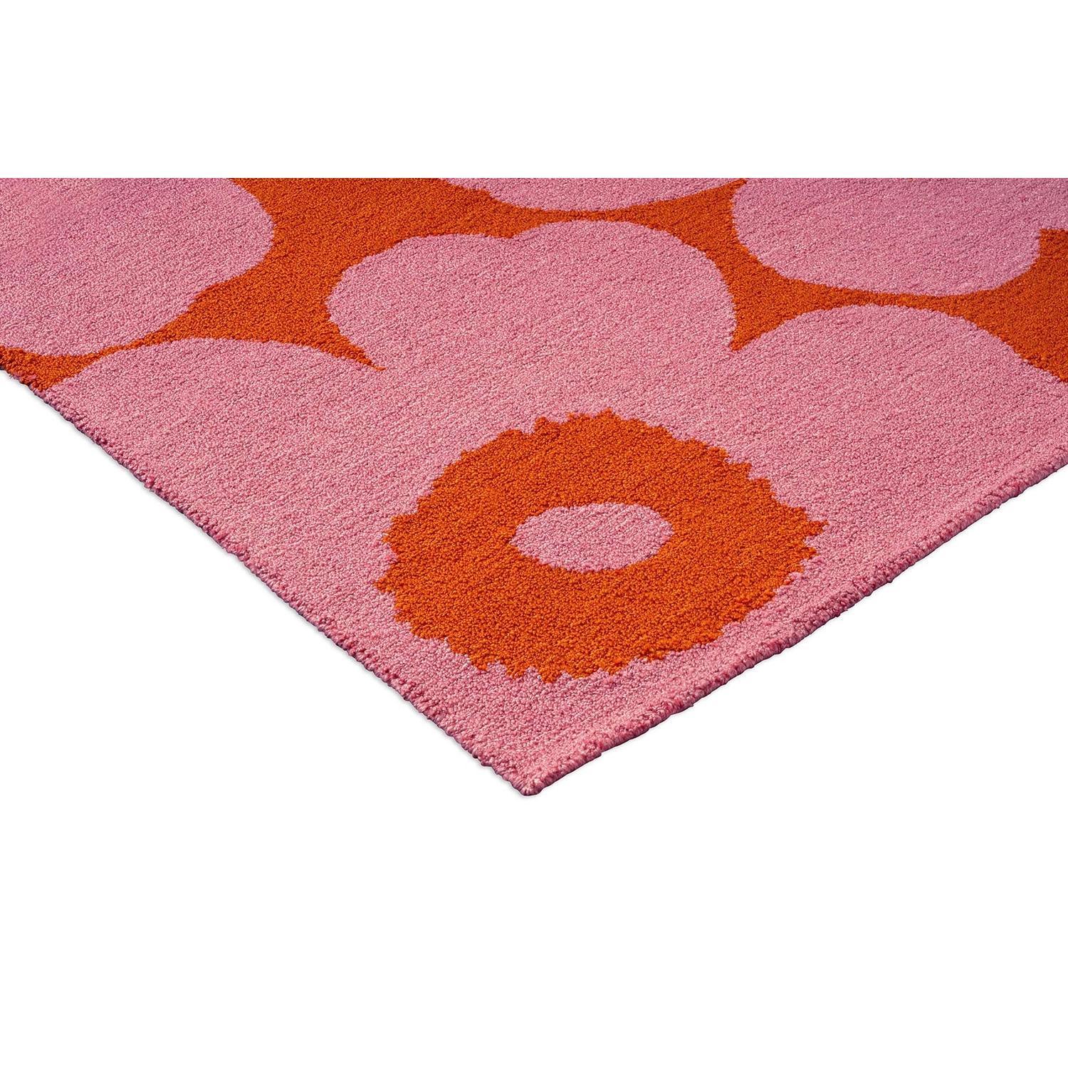 Marimekko Unikko Outdoor Rug featuring floral pattern in hot pink, coral and orange on pink background, loomed PP