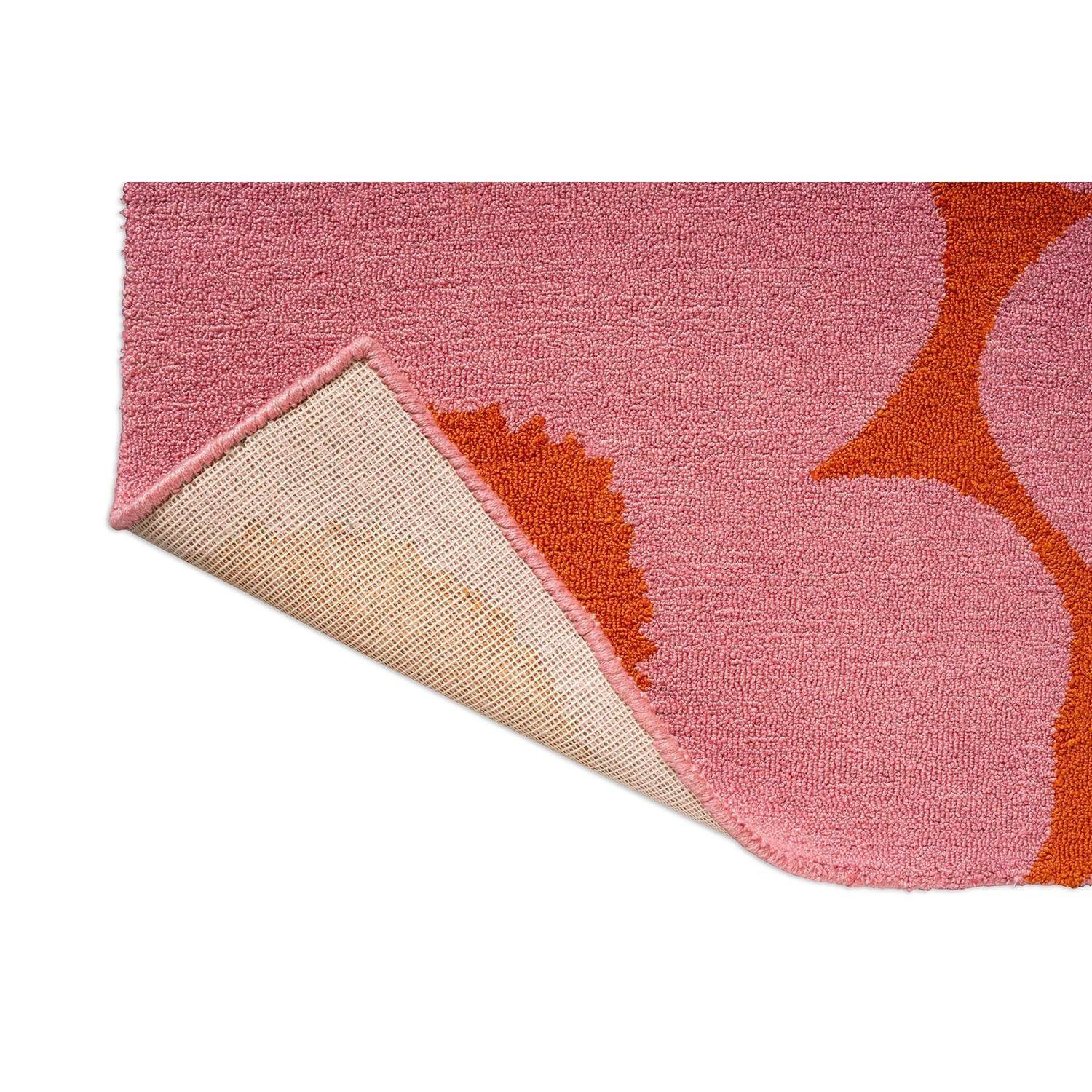 Marimekko Unikko Pink Orange Outdoor Rug featuring floral poppy pattern in rose pink, hot pink and orange on pink background, power-loomed polypropylene