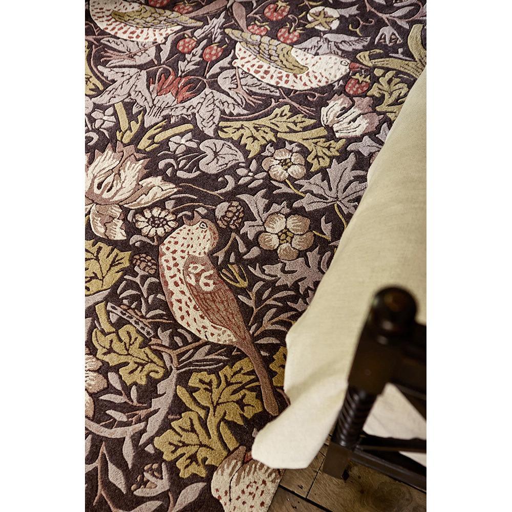 Morris & Co Strawberry Thief rug featuring bird-and-floral pattern in grape purple, olive, cream, rust on dark plum background, hand-tufted wool