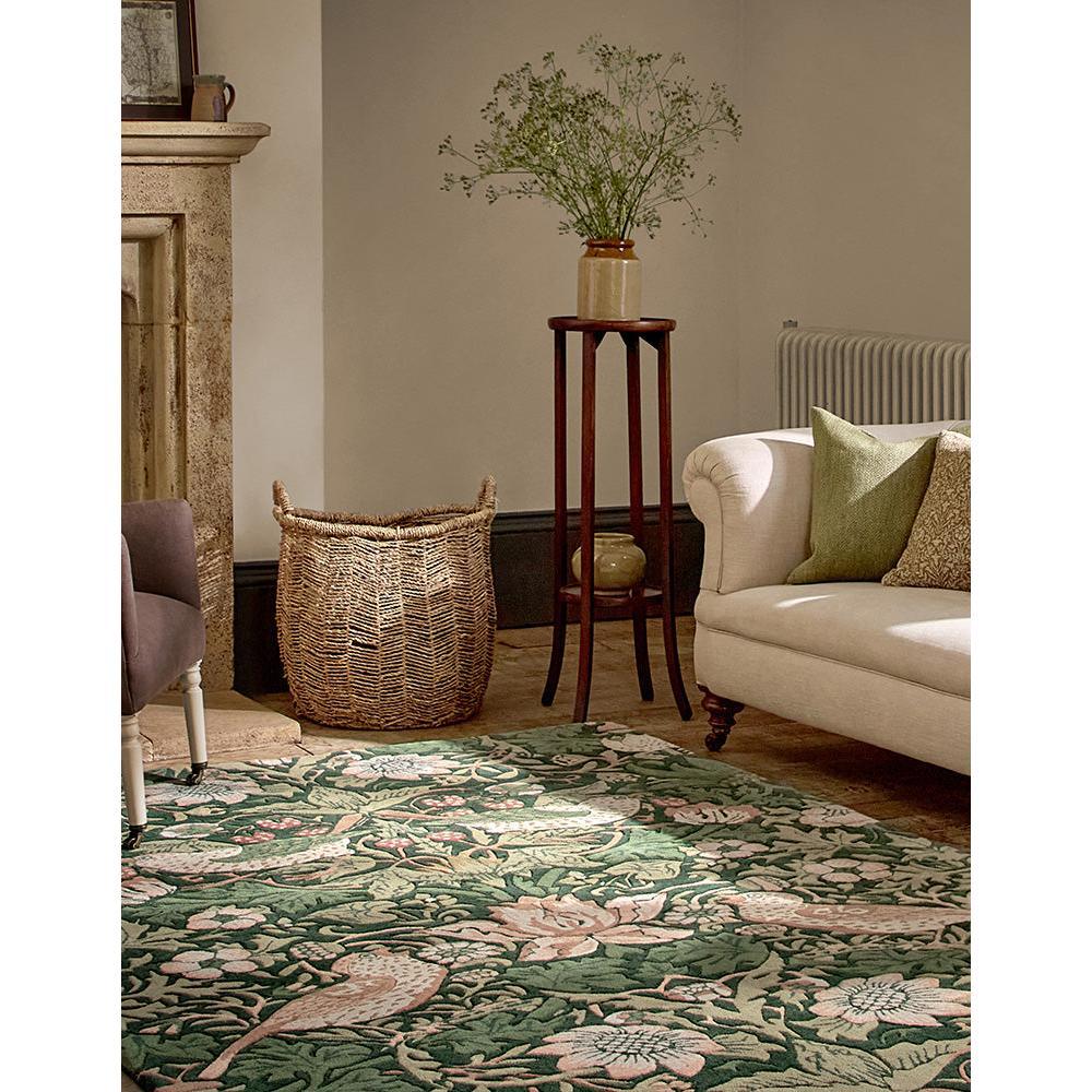 Morris & Co Strawberry Thief Forest Rug featuring botanical pattern in forest green, dusty pink and cream on beige background, hand-tufted wool