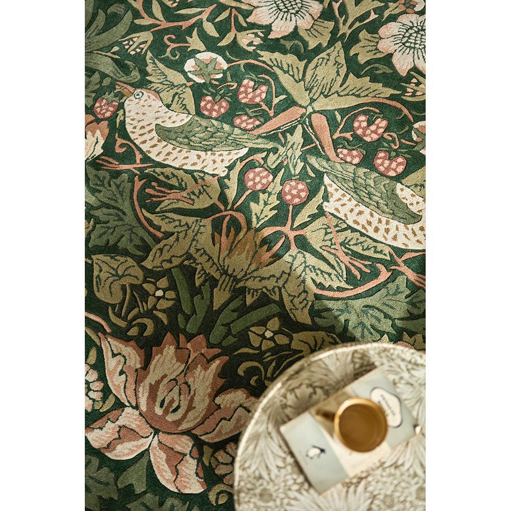 Morris & Co Strawberry Thief Forest rug featuring botanical pattern in emerald green, sage, blush pink and ivory on dark forest green background, hand-tufted wool