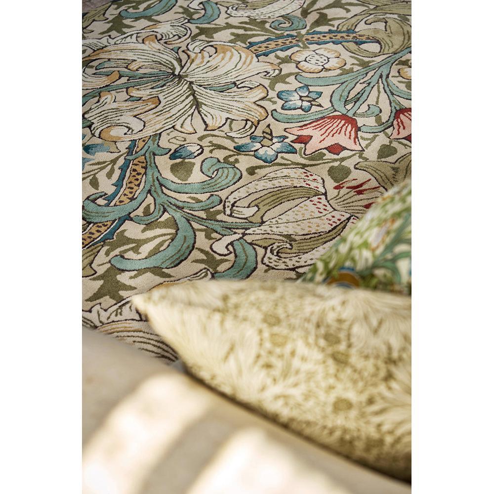 Morris & Co Golden Lily Green - Red Rug featuring botanical floral motif in emerald green, teal, cream, gold on beige background, hand-tufted wool