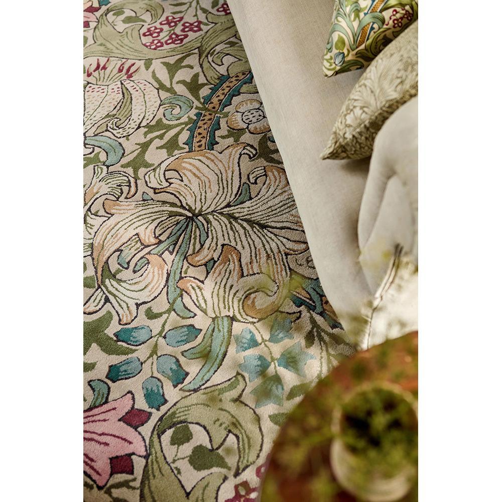 Morris & Co Golden Lily Green - Red Designer Rug featuring botanical floral pattern in emerald green, pink, blue on cream background, hand-tufted wool