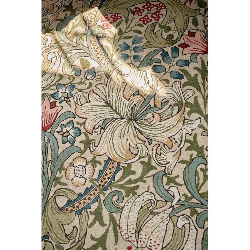 Morris & Co Golden Lily rug featuring botanical floral pattern in cream, sage green, olive, gold and red on beige, hand-tufted wool