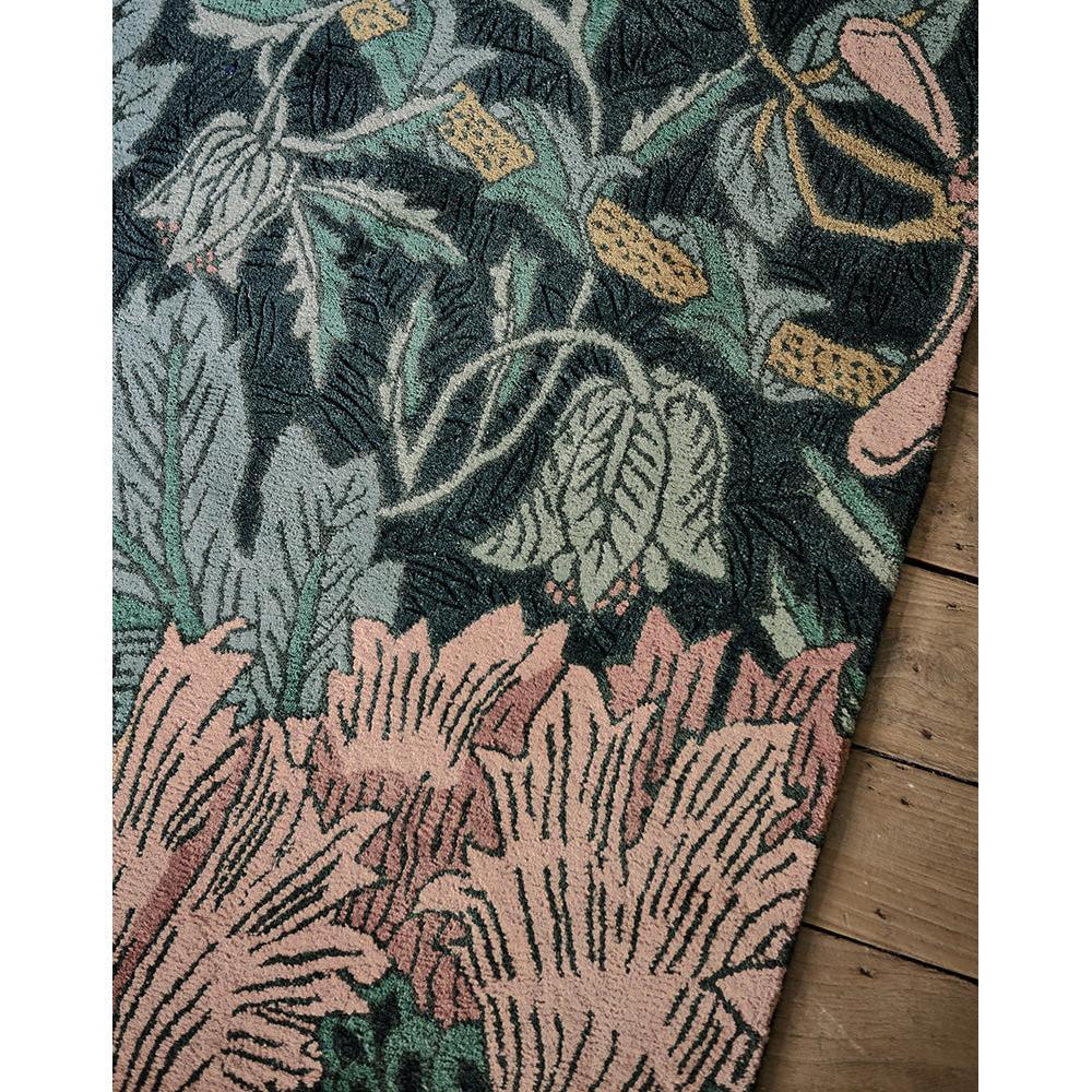Morris & Co Honeysuckle & Tulip Teal rug featuring floral pattern in teal, blush pink and sage green on dark charcoal, hand-tufted wool