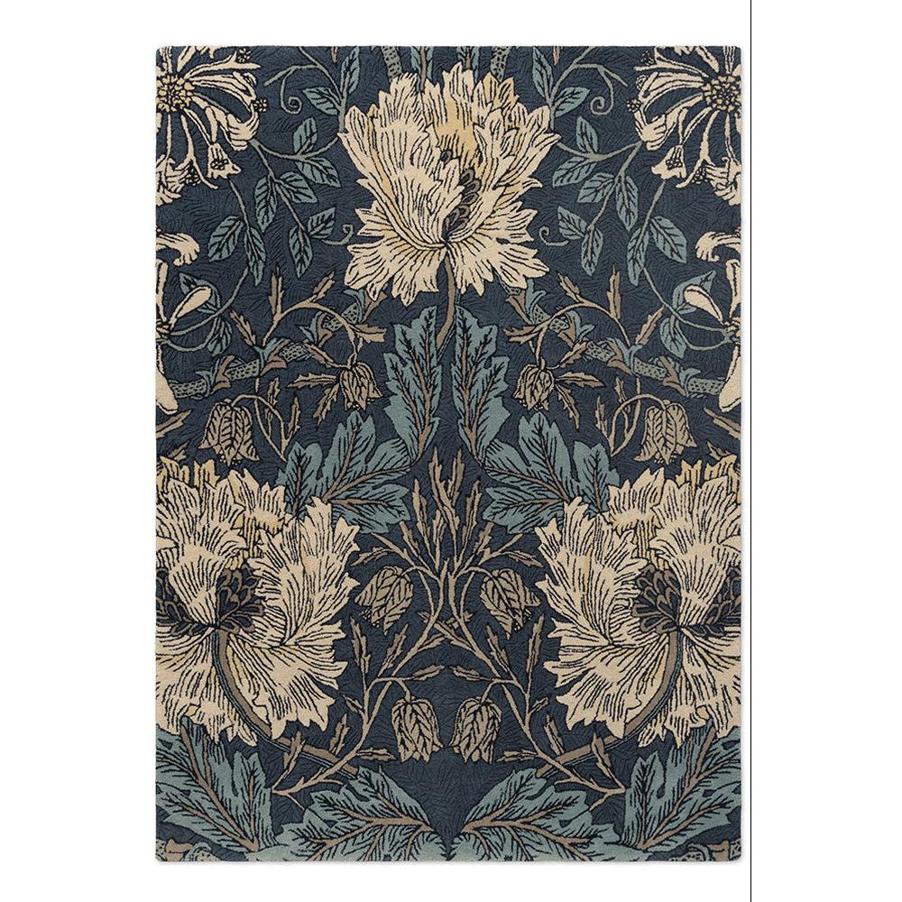 Morris and Co Honeysuckle and Tulip Woad Thyme hand-tufted wool rug featuring William Morris 1876 design with entwined honeysuckle and tulip blooms in deep navy woad, soft sage thyme, cream, and golden tan
