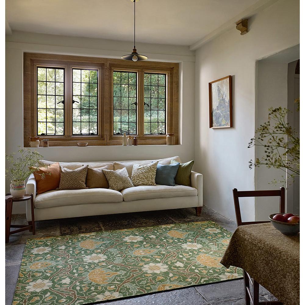Morris & Co Montreal Forest Rug featuring botanical floral pattern in forest green, ochre and ivory on beige background, hand-tufted wool