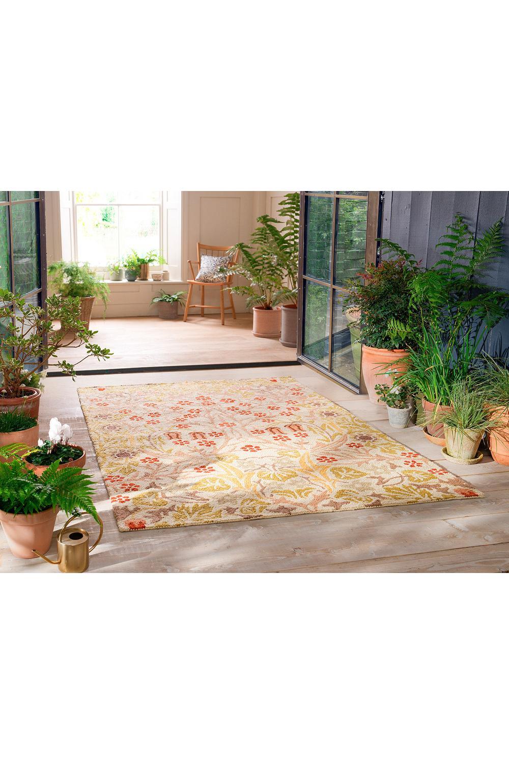 Morris & Co Blackthorn - Wheat outdoor rug featuring botanical floral pattern in wheat yellow, ochre and coral on cream, machine-made polypropylene