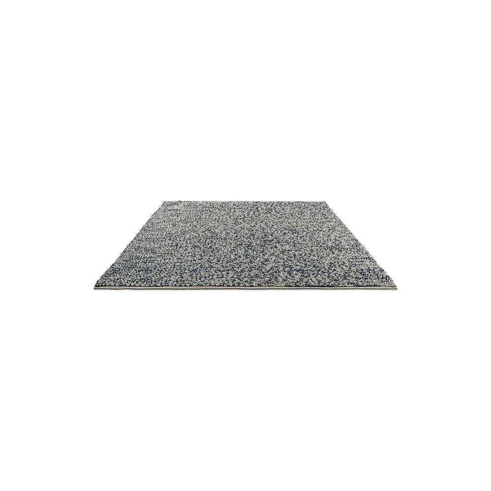 Nest Ink Designer Rug featuring speckled pattern in navy blue, ivory and heather grey on light grey, hand-tufted wool