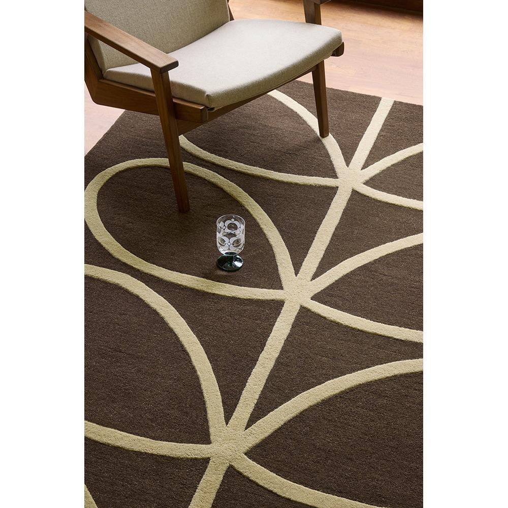 Orla Kiely Giant Linear Stem Walnut Designer Rug featuring linear stem pattern in cream on walnut brown background, hand-tufted wool