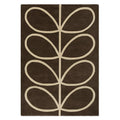 Orla Kiely Giant Linear Stem Walnut hand-tufted wool rug featuring dramatically oversized stem leaf motif in vertical columns with cream outlines on rich chocolate walnut brown background
