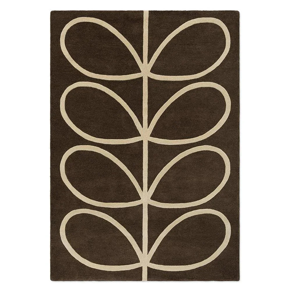 Orla Kiely Giant Linear Stem Walnut hand-tufted wool rug featuring dramatically oversized stem leaf motif in vertical columns with cream outlines on rich chocolate walnut brown background
