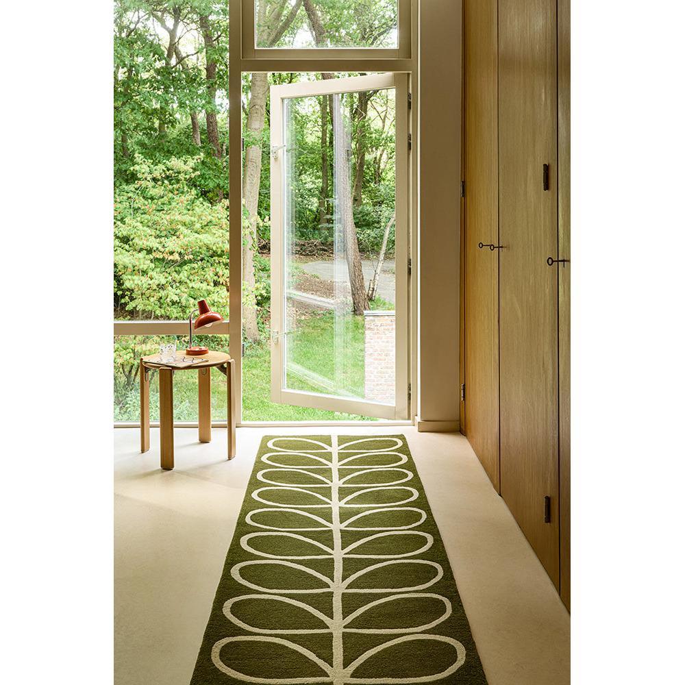 Orla Kiely Linear Stem Olive Designer Rug featuring linear stem pattern in olive green and white on cream background, hand-tufted wool