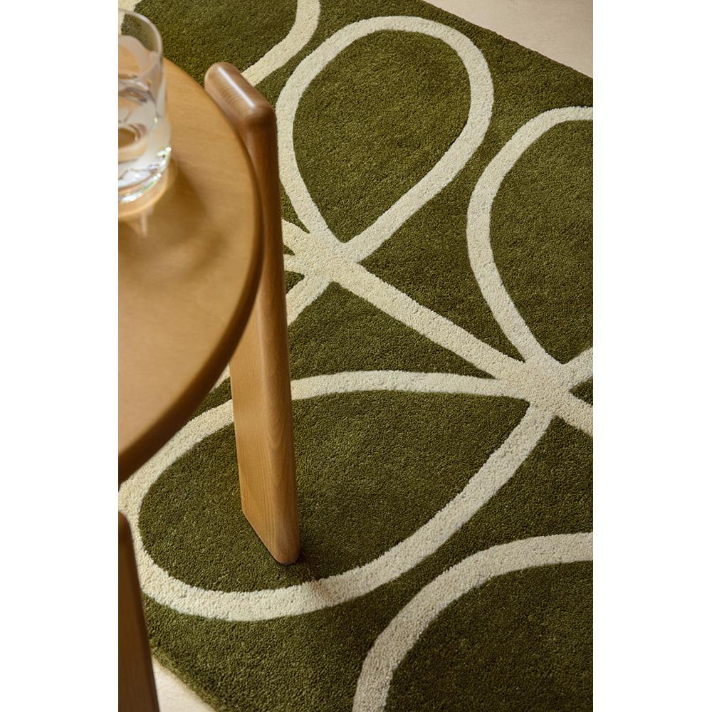 Orla Kiely Linear Stem Olive Runner Rug with curved stem pattern in olive and ivory on beige background, hand-tufted wool
