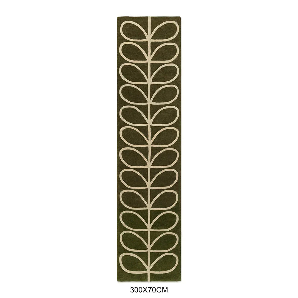 Orla Kiely Linear Stem Olive Rug featuring cream leaf pattern on olive background, hand-tufted wool