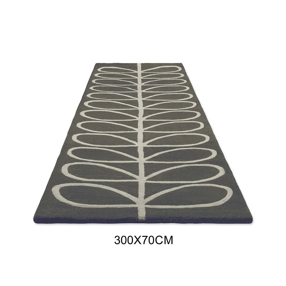 Orla Kiely Linear Stem Slate Runner Rug featuring white linear leaf stem pattern on slate grey background, hand-tufted wool