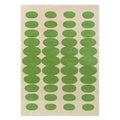 Orla Kiely Optical Oval Green Cream hand-tufted wool rug featuring hypnotic interlocking oval pattern in rich grass green on soft cream background
