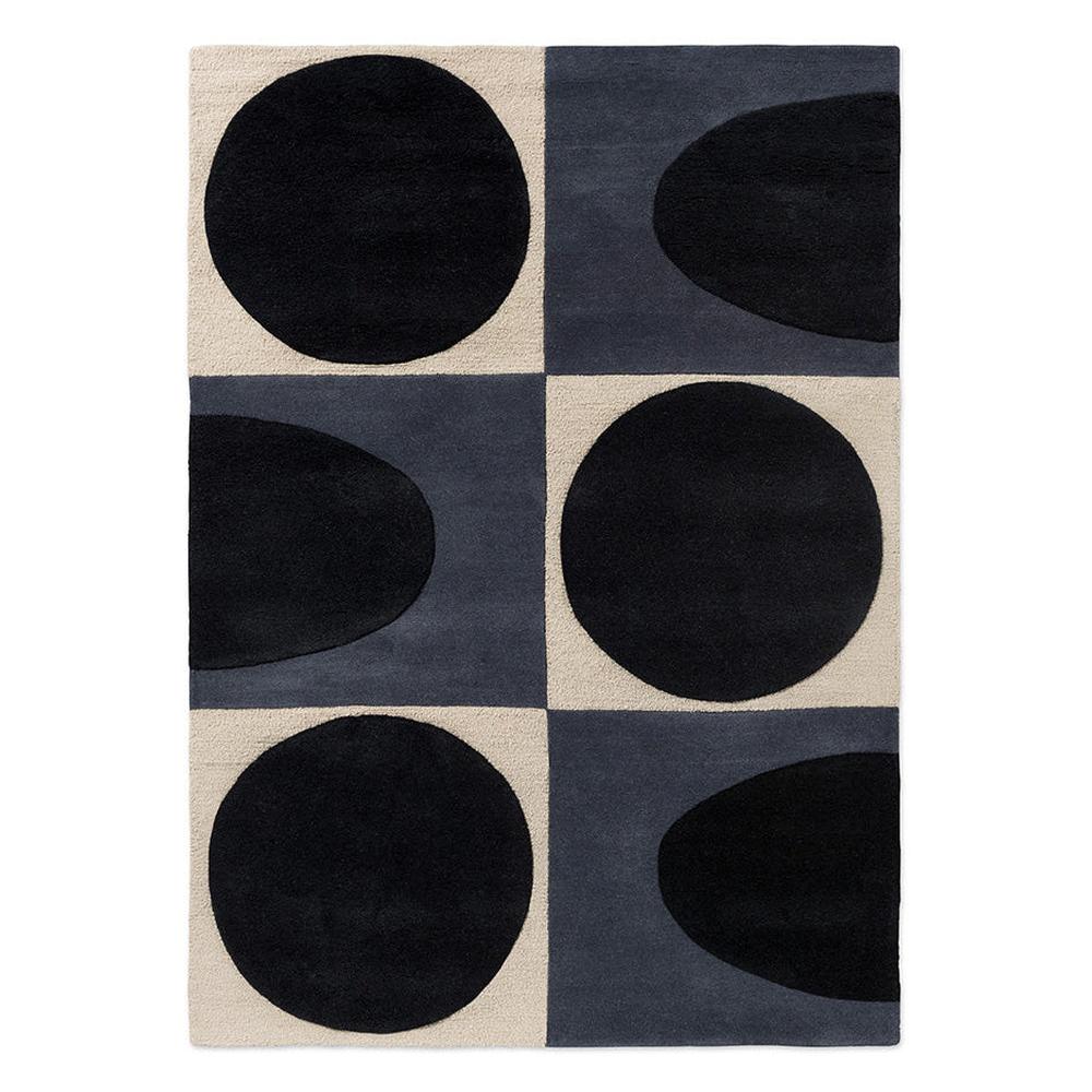 Orla Kiely Spot Square Blue Navy hand-tufted wool rug featuring bold mid-century geometric pattern with black circles and half-circles on slate blue and cream blocks
