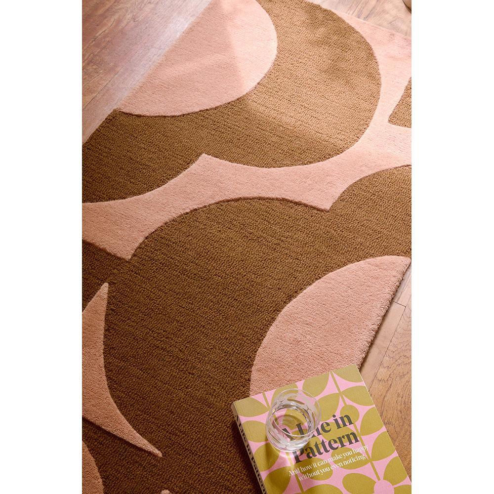Orla Kiely Prism Flower Pink Terracotta Designer Rug featuring circular floral pattern in pink, terracotta and cream on light pink background, construction not specified, material not specified