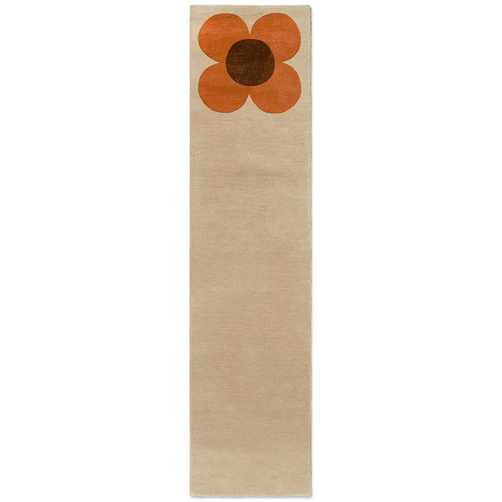 Orla Kiely Flower Placement Pumpkin Ecru runner rug featuring oversized iconic flower bloom in warm pumpkin orange with chocolate brown centre dramatically placed on soft ecru cream background

