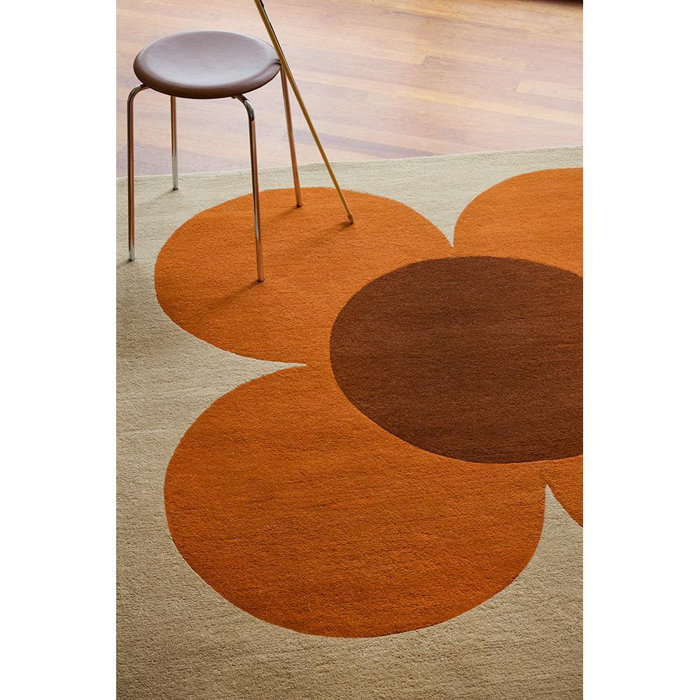 Orla Kiely Flower Placement Pumpkin Ecru Rug featuring bold circular petals in pumpkin orange and chocolate brown on beige, hand-tufted wool