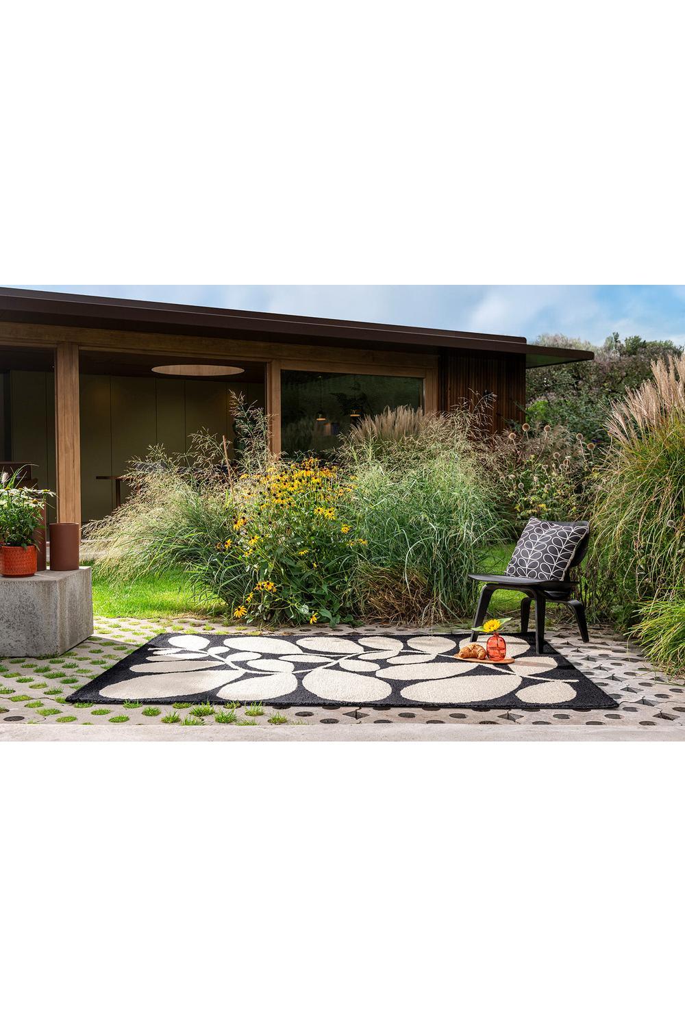 Orla Kiely Sycamore Black Outdoor Rug featuring cream petal pattern on black border, outdoor power-loomed polypropylene