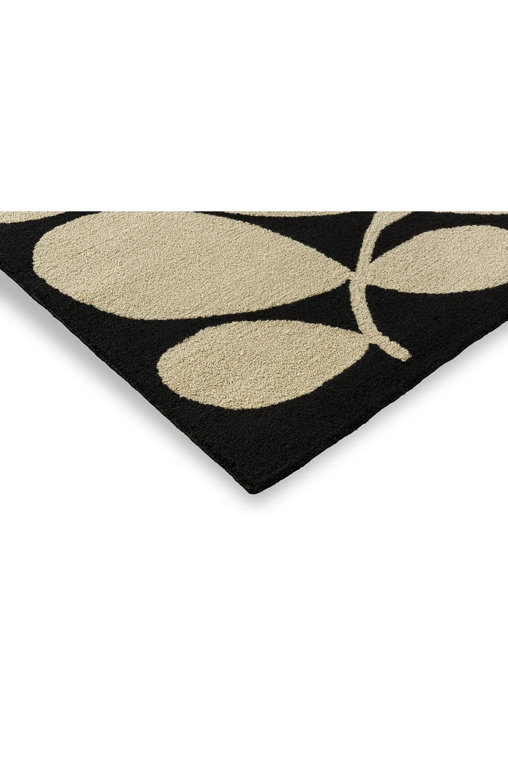 Orla Kiely Sycamore Black outdoor rug featuring leaf pattern in beige on black background, machine-made polypropylene