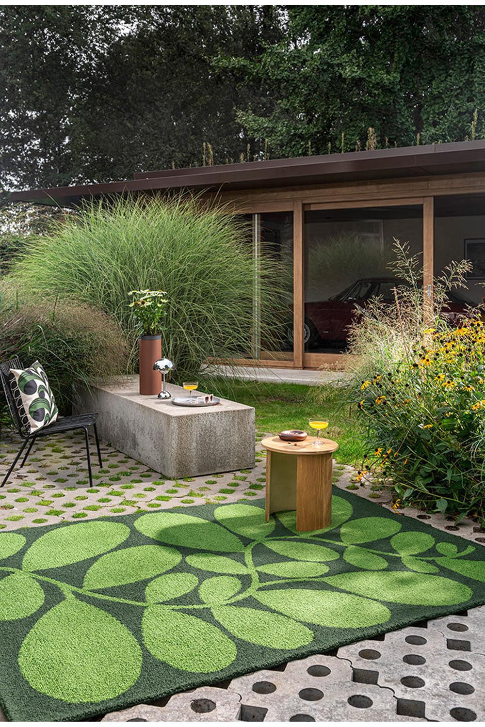 Orla Kiely Sycamore Dill Outdoor Rug featuring leafy botanical pattern in lime, sage, emerald on dark green background, power-loomed polypropylene