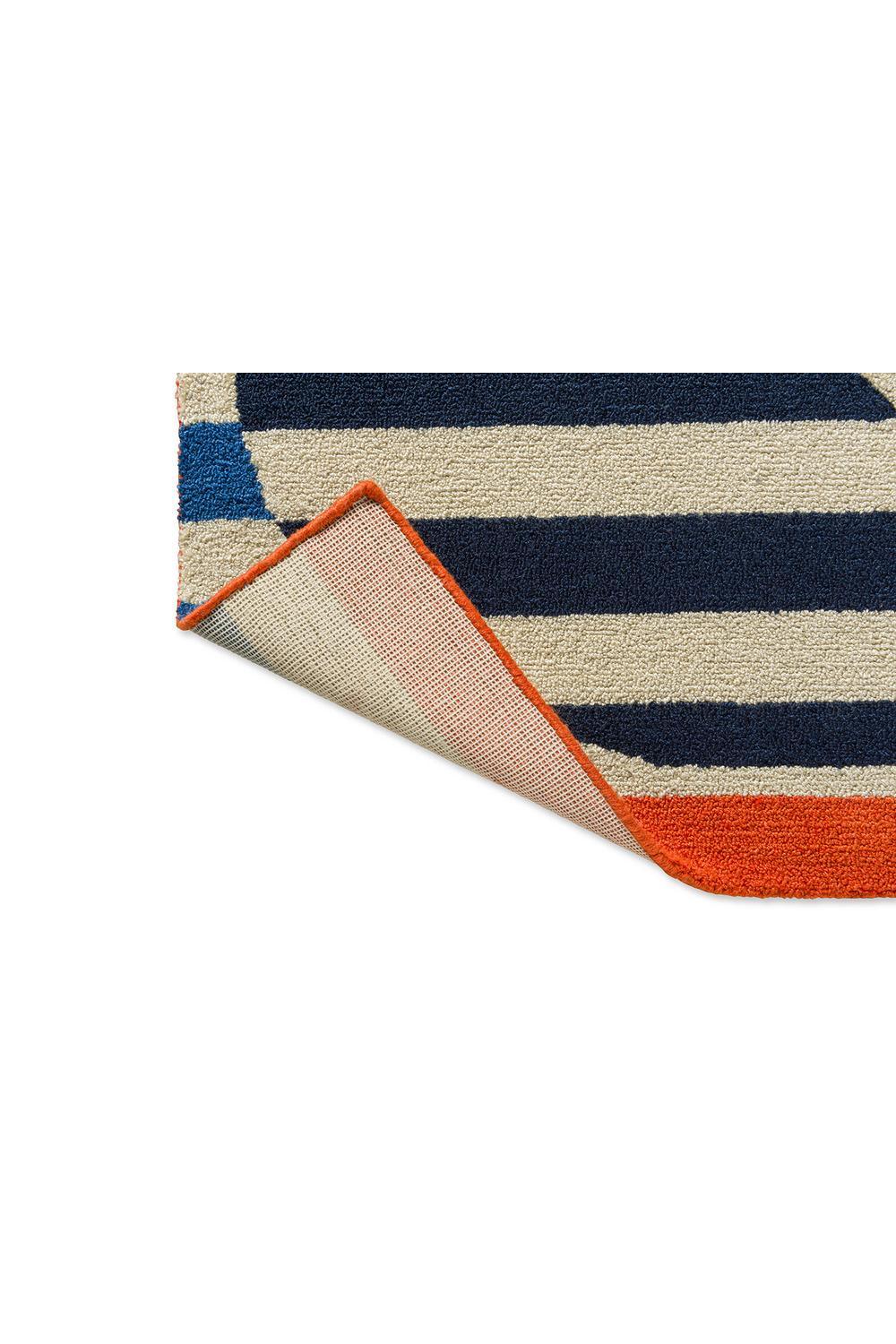Orla Kiely Stripy Stem Azure Outdoor Rug featuring navy, cream and orange stripes on cream ground, machine-woven polypropylene