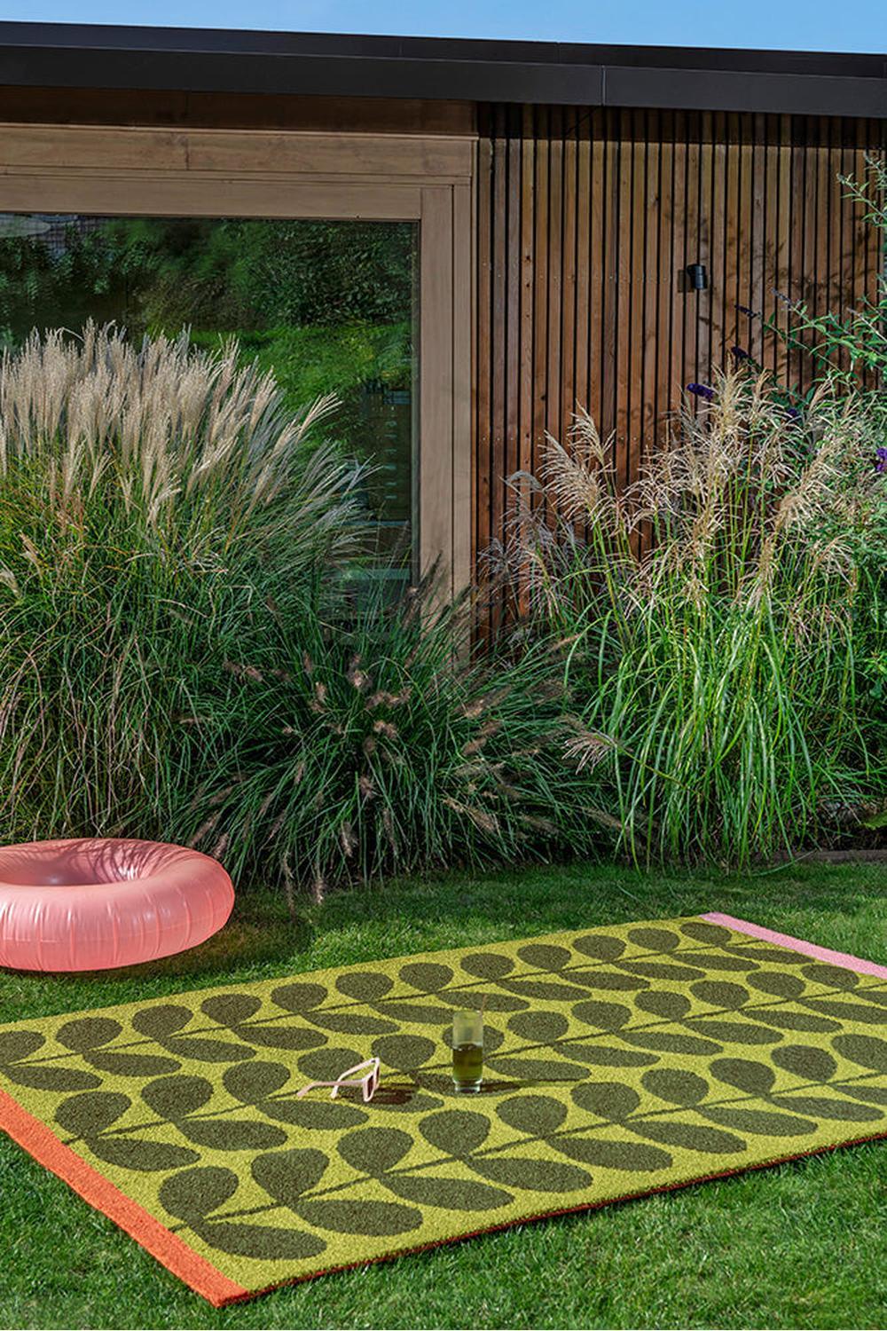 Orla Kiely Solid Stem Seagrass Outdoor Rug featuring stem motif in olive, lime and chocolate on pale yellow background, hand-woven seagrass