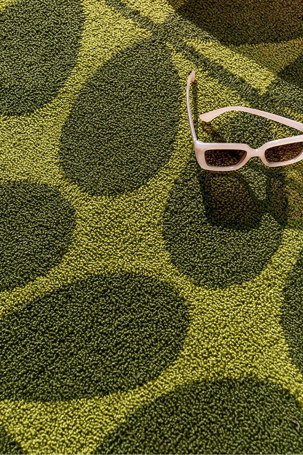 Orla Kiely Solid Stem Seagrass outdoor rug with geometric leaf pattern in lime green, olive & dark green on yellow background, handwoven