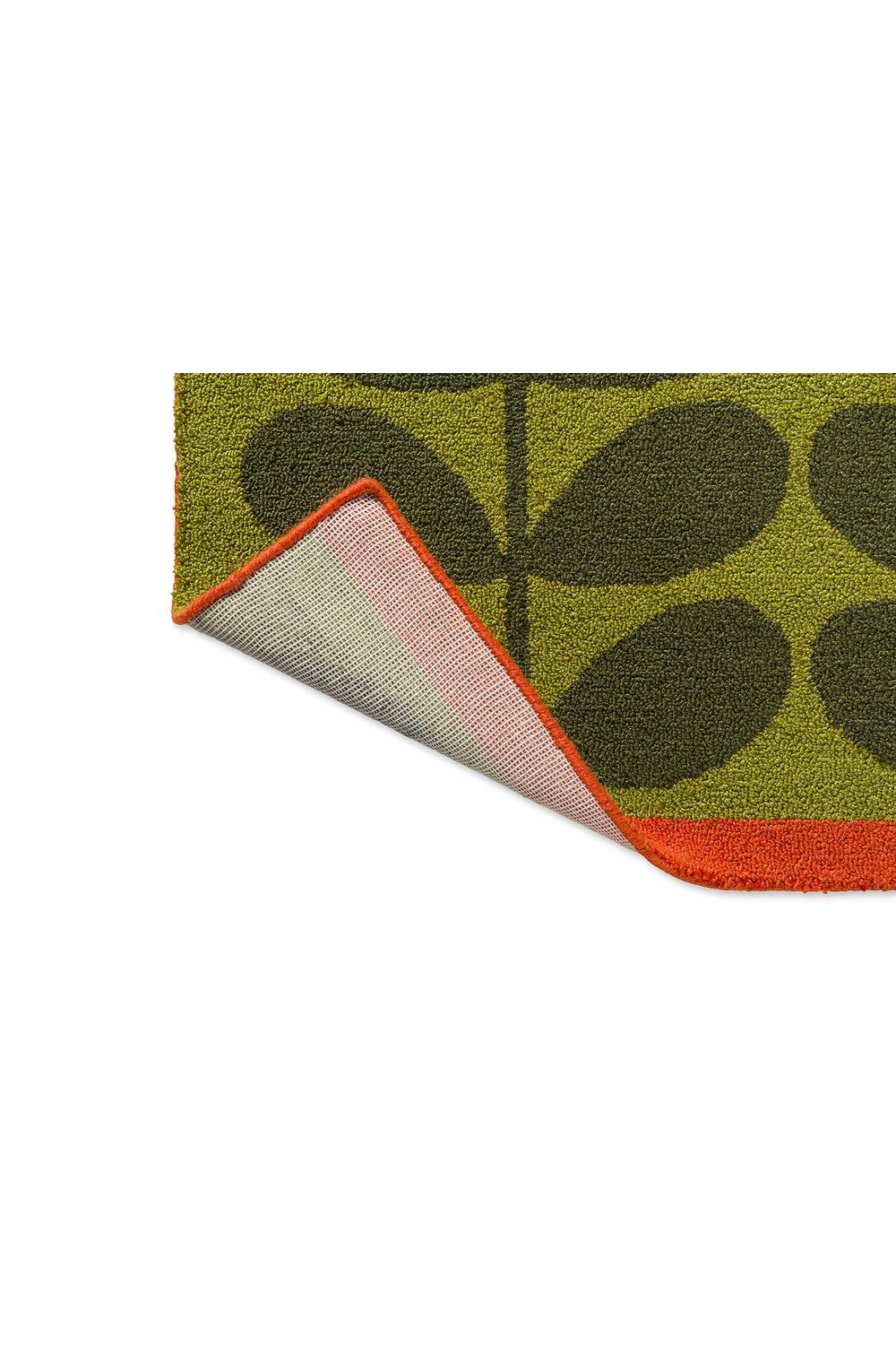 Orla Kiely Solid Stem Seagrass outdoor rug featuring stem pattern in olive green, dark green and orange on lime background, power-loomed polypropylene