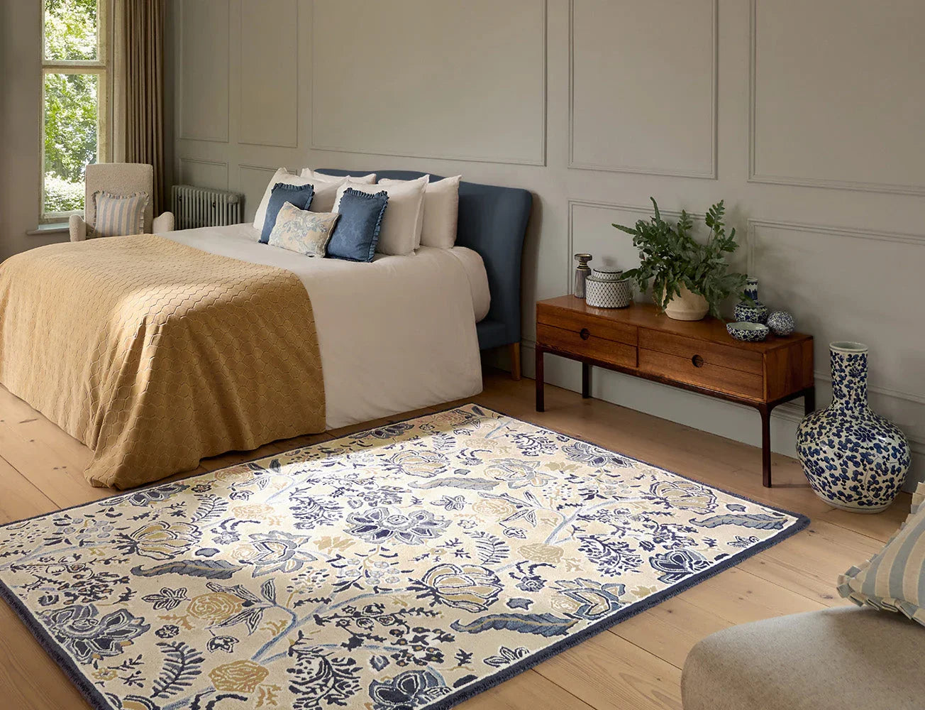 Sanderson Shalimar China Blue Designer Rug featuring floral pattern in china blue, navy, cream and pale yellow on cream background, hand-tufted wool