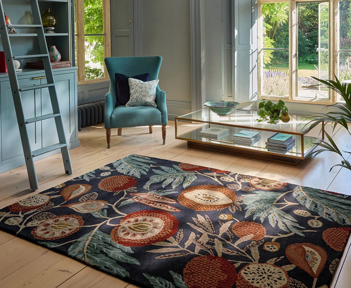 Sanderson Jackfruit Turmeric Indigo Designer Rug featuring tropical floral pattern in navy, teal, turmeric and cream on dark blue, hand-tufted wool