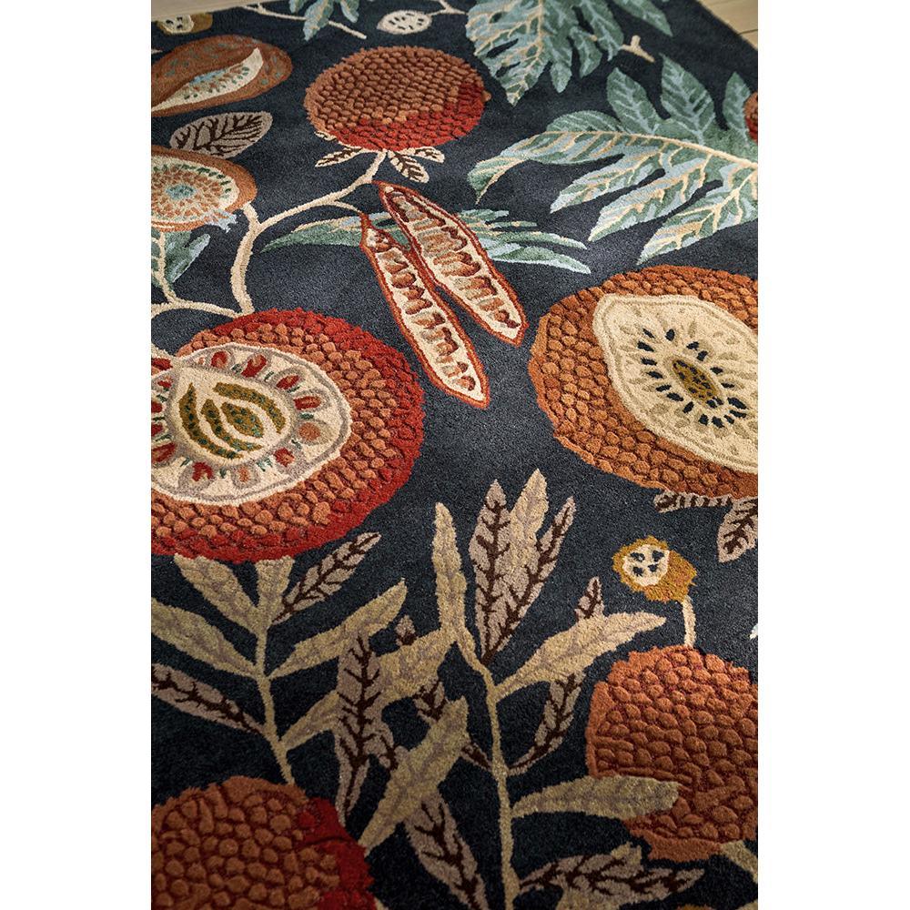 Sanderson Jackfruit Turmeric Indigo Designer Rug featuring botanical fruit motif in navy, turmeric yellow, burnt orange and cream on navy background, hand-tufted wool