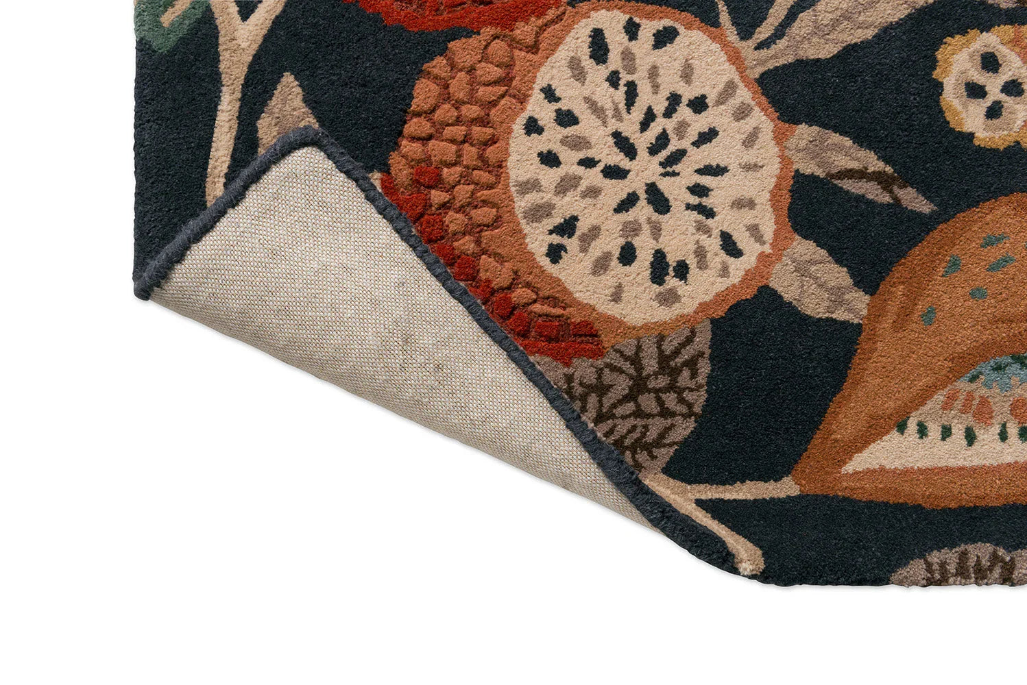 Sanderson Jackfruit Turmeric Indigo Rug featuring botanical floral pattern in turmeric, navy, cream on dark navy, hand-tufted wool