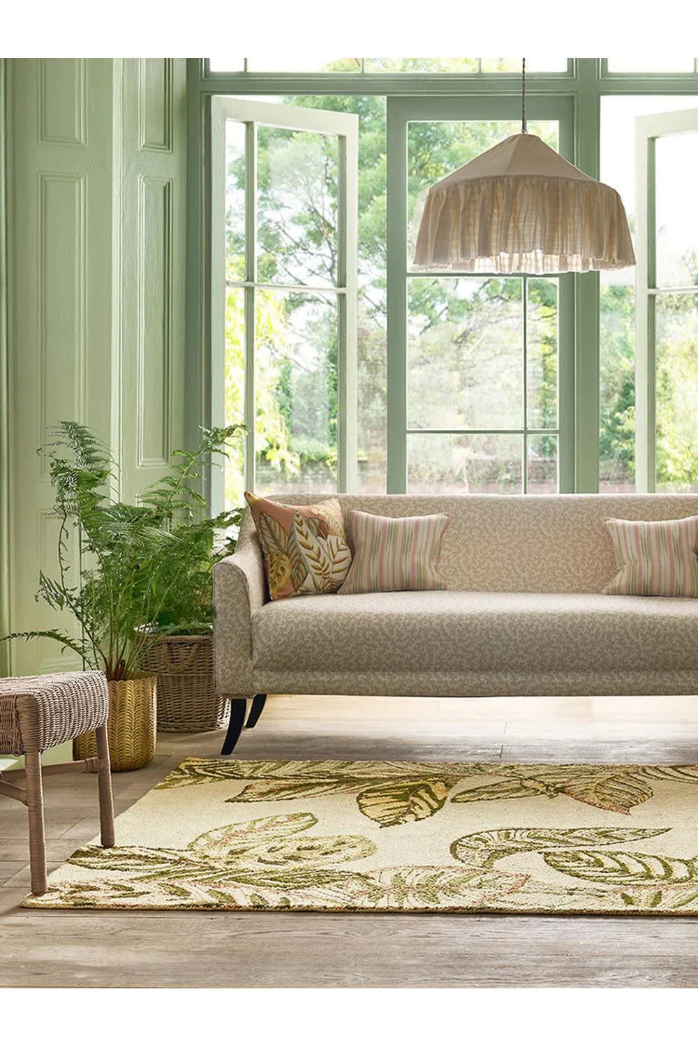 Sanderson Calathea Samphire Designer Outdoor Rug featuring botanical leaf pattern in sage green, olive, cream and brown on beige background, outdoor polypropylene